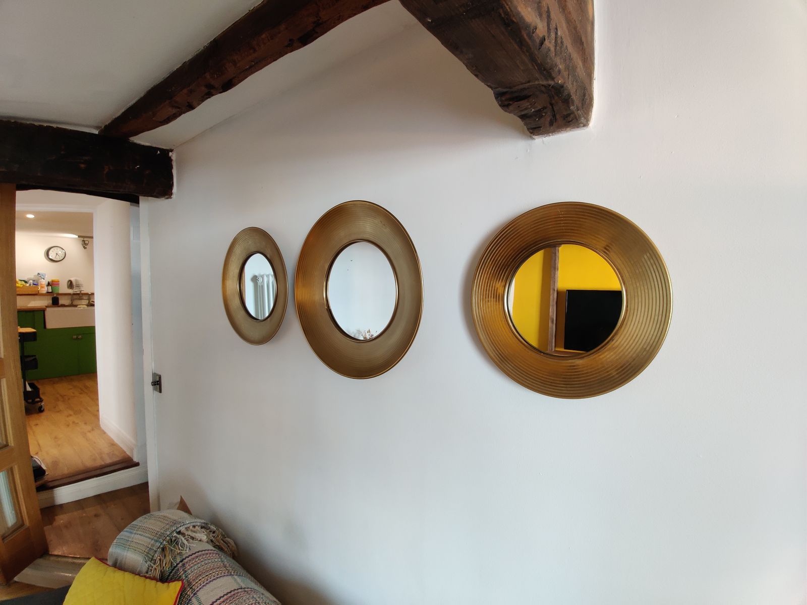 Characterful landing with gold mirrors, looking through to the kitchen